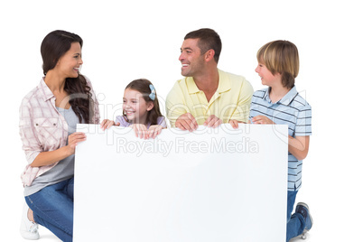 Family with billboard over white background