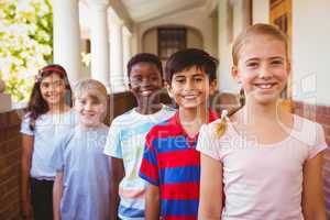 Smiling little school kids in school corridor