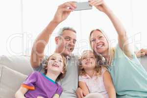 Parents taking selfie with children