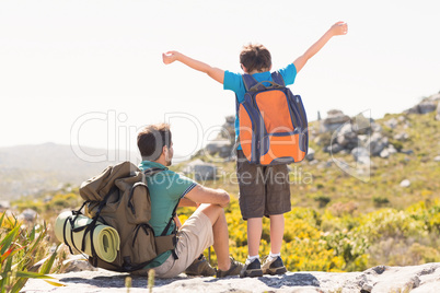 Father and son hiking through mountains