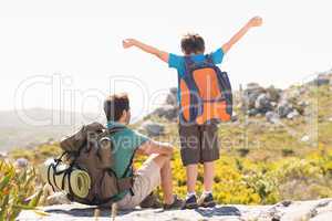 Father and son hiking through mountains