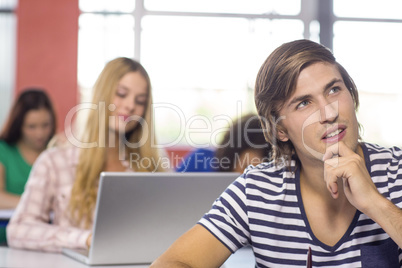 Thoughtful male student in classroom