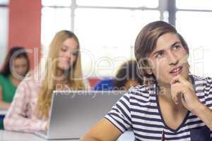 Thoughtful male student in classroom