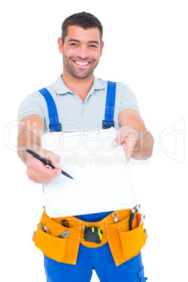 Smiling handyman giving clipboard for signature