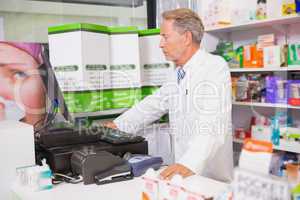 Senior pharmacist using the computer