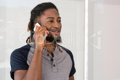 Young casual man using mobile phone