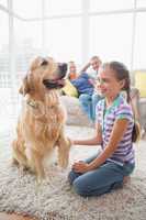 Girl playing with dog while parents relaxing at home