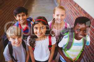 Smiling little school kids in school corridor