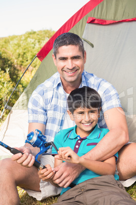 Father and son beside tent