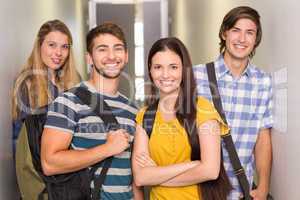 Happy students at college corridor