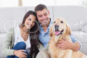 Couple with Golden Retriever in living room