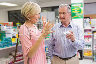 Smiling couple speaking about medication