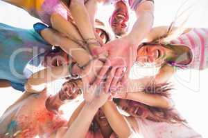 Happy friends covered in powder paint