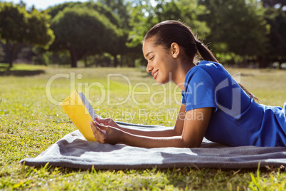 Pretty woman reading in the park