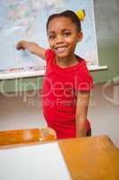 Girl pointing at map in classroom
