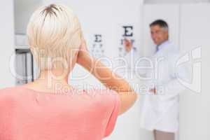 Blonde woman doing eye exam