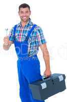 Smiling male repairman with toolbox and spanner