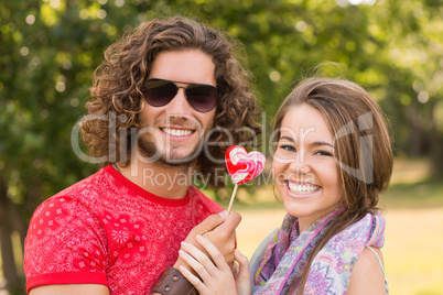 Cute couple sharing a lollipop