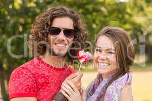 Cute couple sharing a lollipop