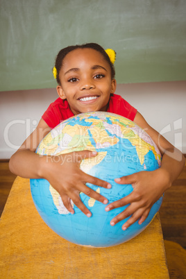 Cute little girl holding globe