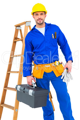 Smiling handyman holding tool box