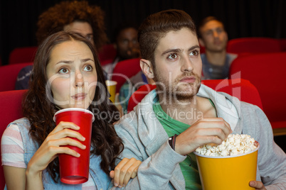 Young couple watching a film