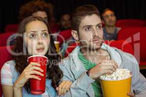 Young couple watching a film
