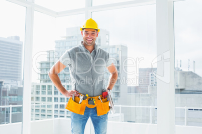 Smiling handyman standing in building