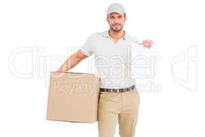 Delivery man with cardboard box showing clipboard