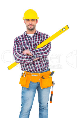 Smiling handyman holding spirit level Smiling handyman holding spirit level