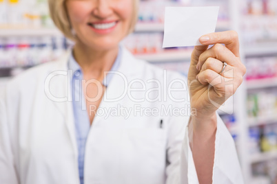 Smiling pharmacist showing calling card