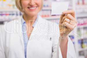 Smiling pharmacist showing calling card