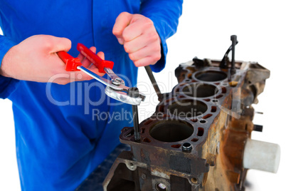 Male mechanic repairing car engine