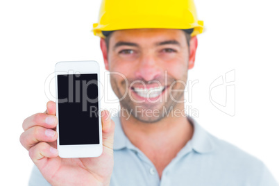 Portrait of smiling handyman showing smart phone