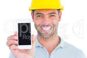 Portrait of smiling handyman showing smart phone