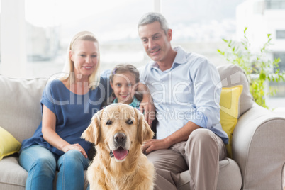 Family with Golden Retriever at home