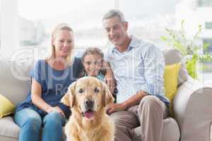 Family with Golden Retriever at home