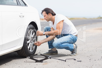 Man changing wheel after a car breakdown