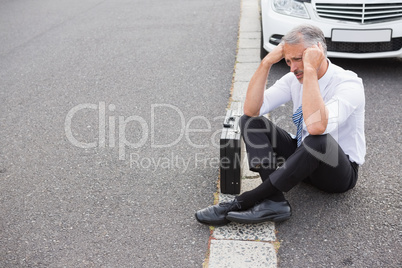 Sad man waiting for assistance after breaking down
