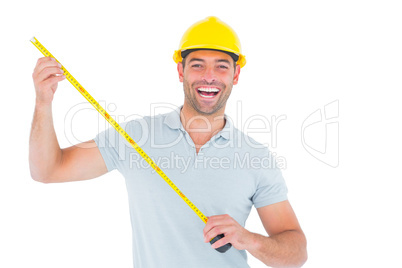 Portrait of cheerful carpenter holding tape measure