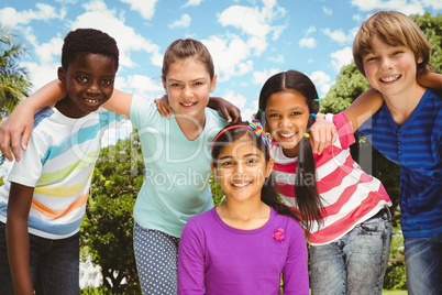 Happy children forming huddle at park