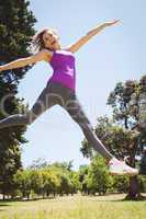 Fit woman leaping in the park