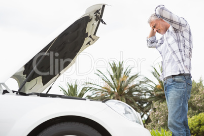 Stressed man looking at engine