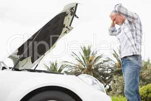 Stressed man looking at engine