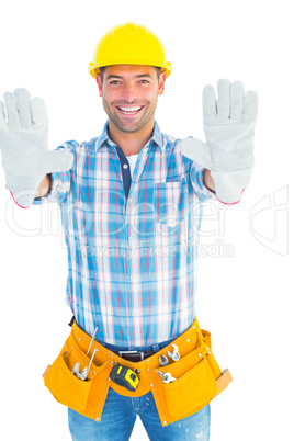 Happy manual worker making stop sign