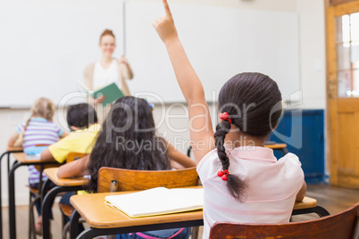 Pupil raising hand in classroom