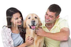 Loving couple stroking dog