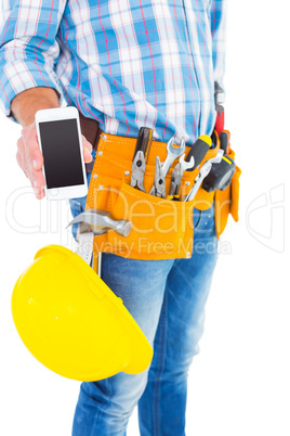 Midsection of handyman showing smartphone