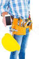 Midsection of handyman showing smartphone