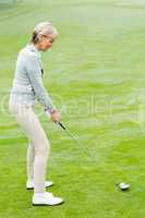 Lady golfer on the putting green